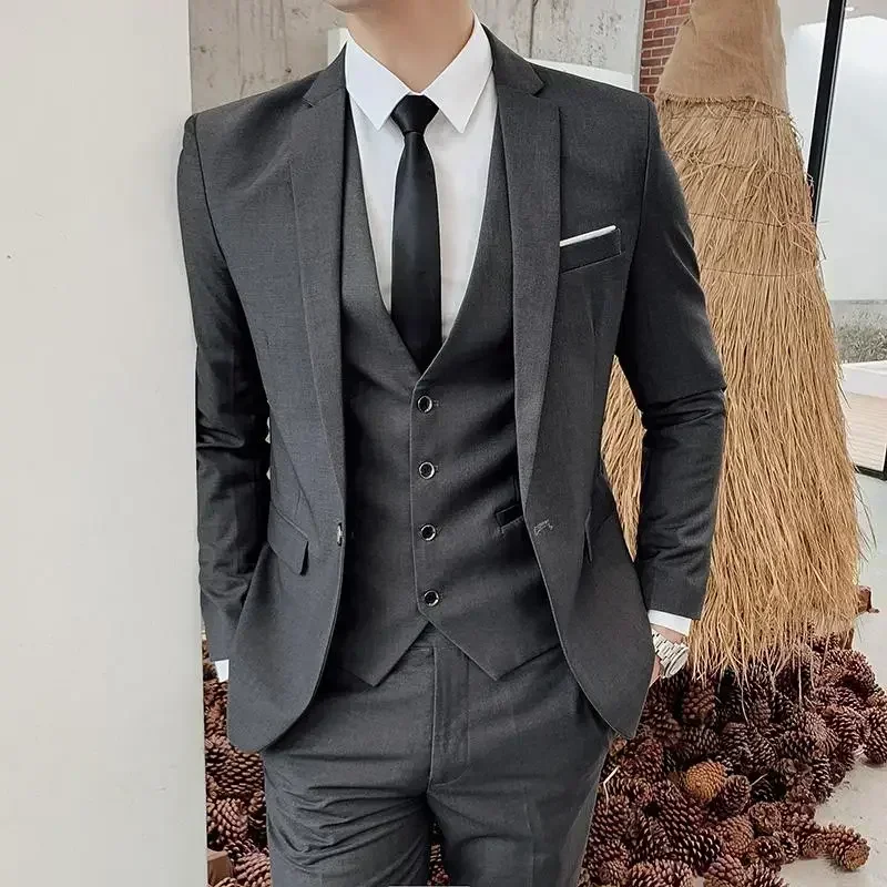 Man wearing a grey men’s 3-piece slim-fit suit, styled for smart-casual and formal occasions Man wearing a grey men’s 3-piece slim-fit suit, styled for smart-casual and formal occasions